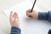 image of hands and pencil with white piece of paper - taking test 