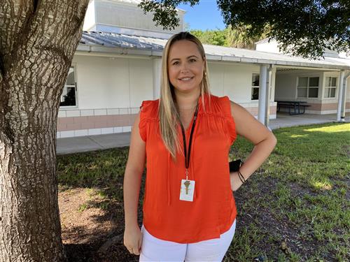 Ms. Paredes outside standing near a tree