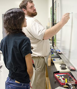 Two People At A White Board In Drafting Class Two People At A White Board In Drafting Class
