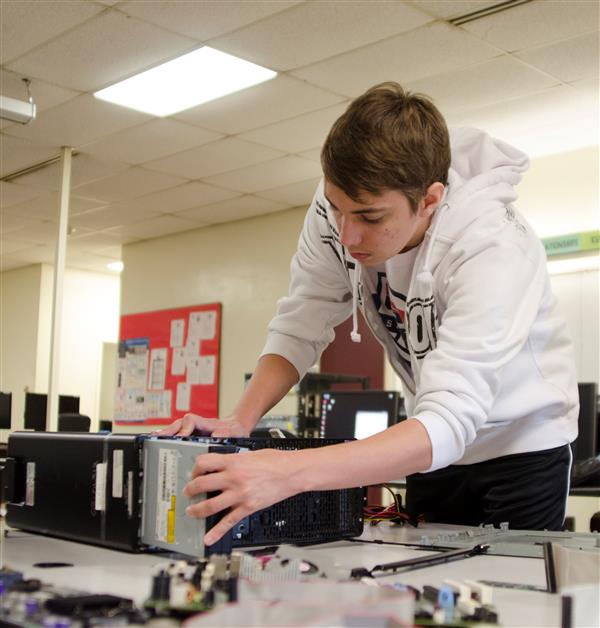 A Student Working on a computer in the network support services calss A Student Working on a computer in the network support services calss