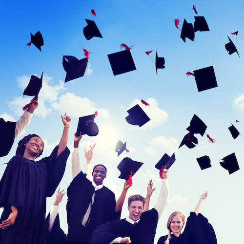 Graduating students throwing their caps in the air 