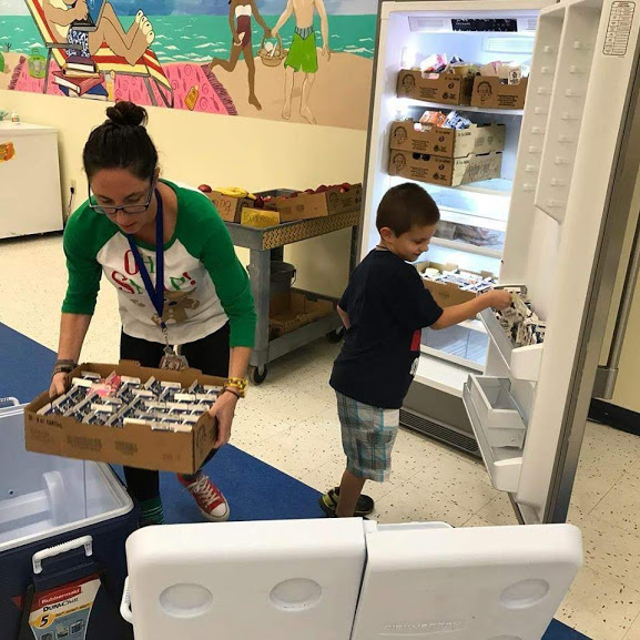 Adult and student loading boxed food