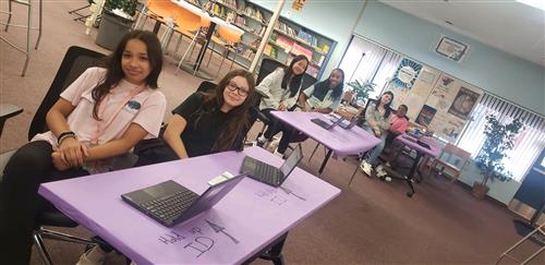 yearbook students at table with laptops