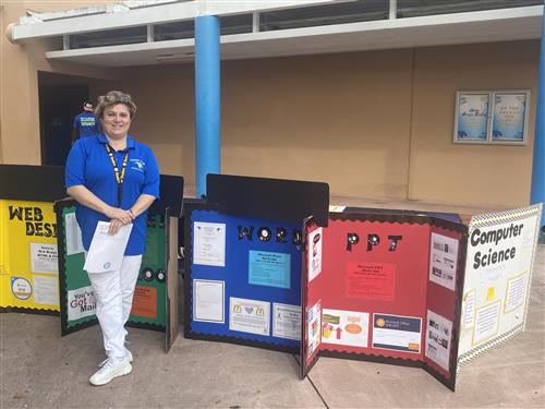 Ms. O'John and her presentation boards for classes