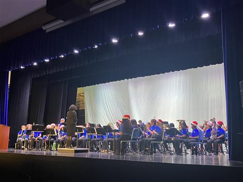 band director and band performing on stage